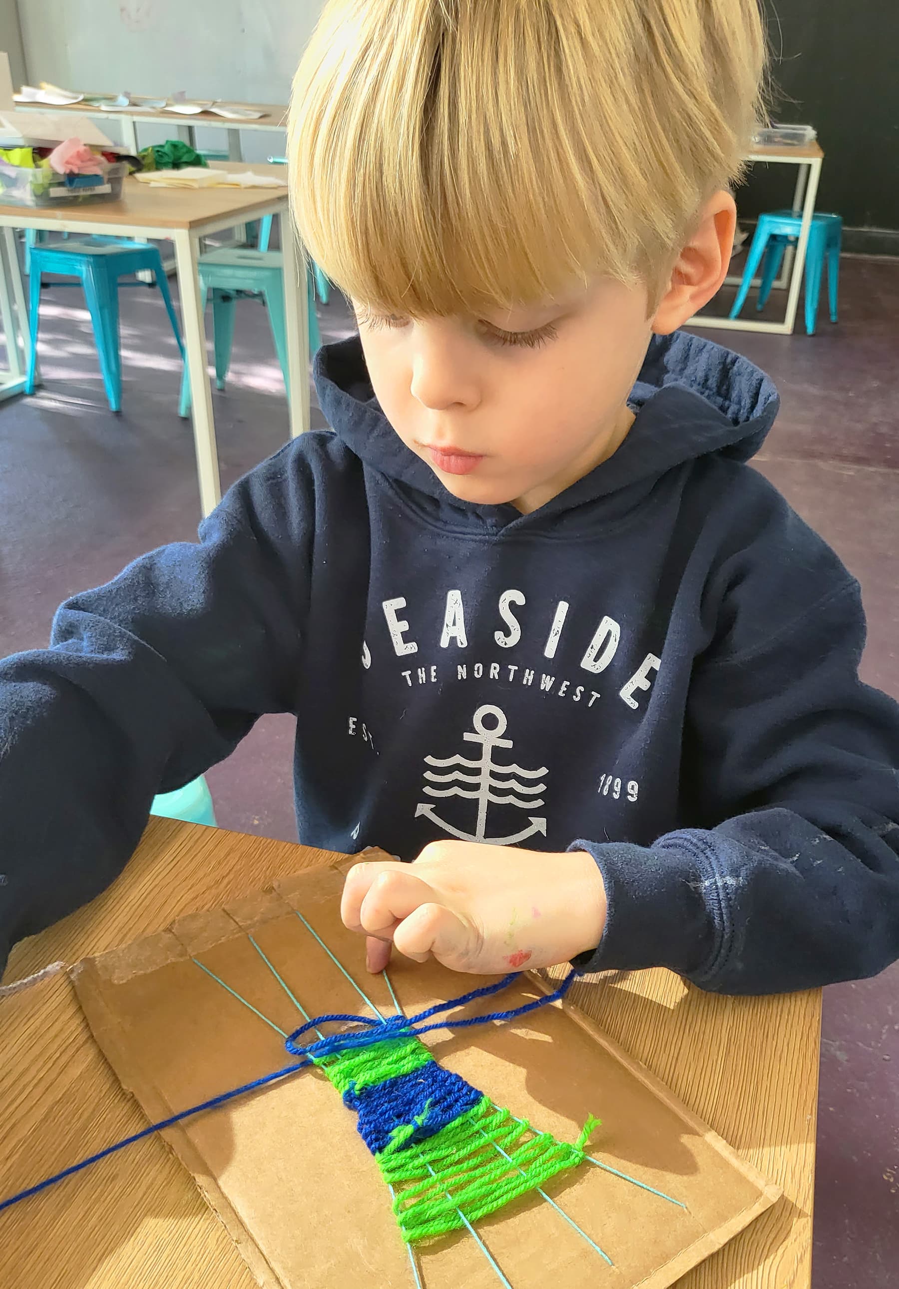 Child weaving at Playday